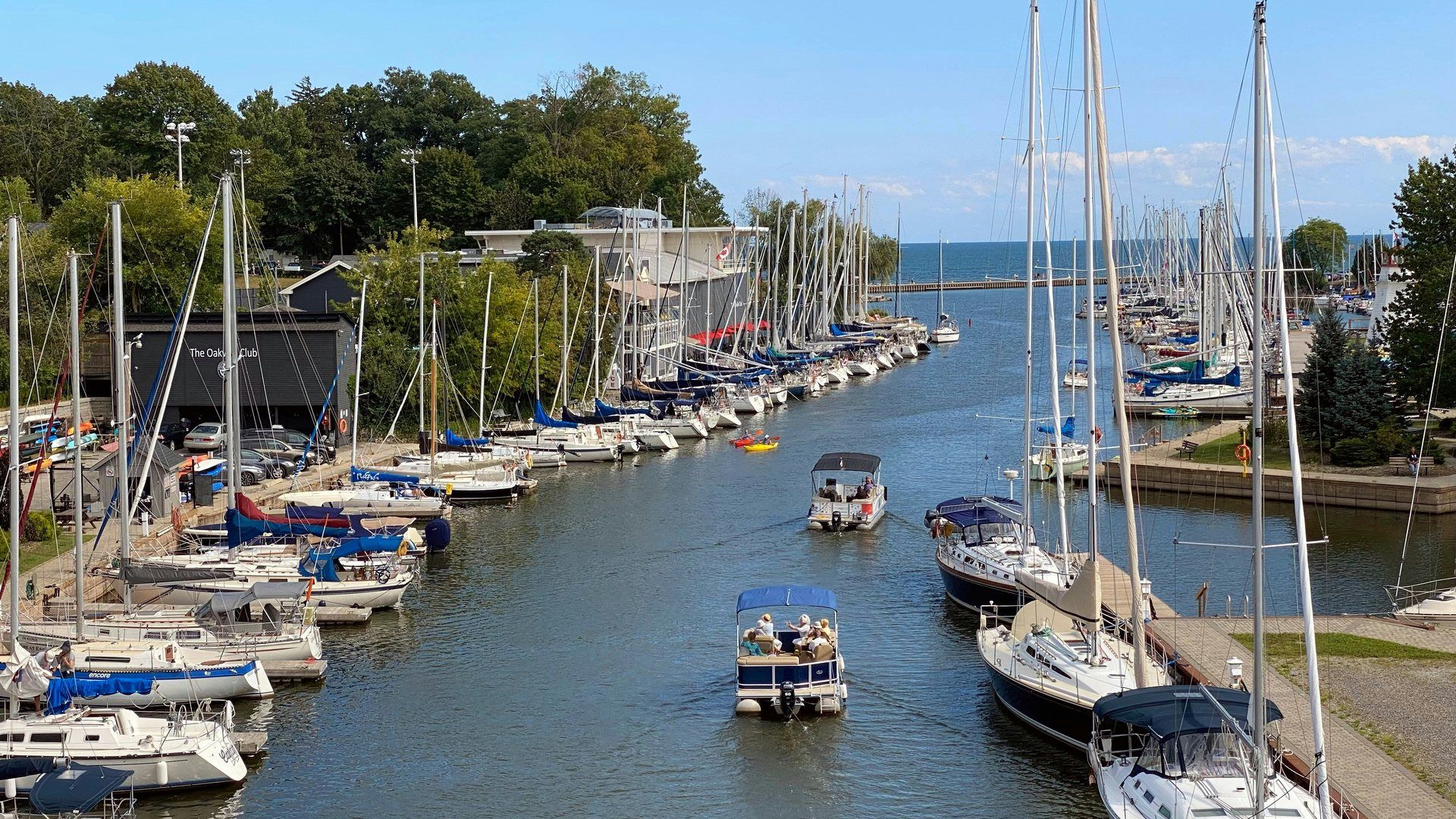 Sailboats moored along Oakville Harbour at Sixteen Mile Creek on a sunny day